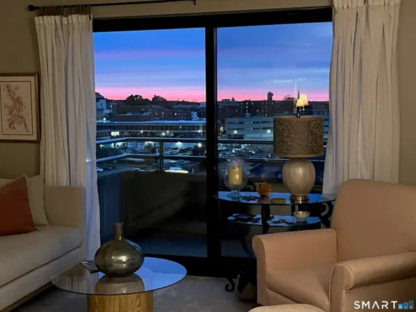 a view of a swimming pool with outdoor seating