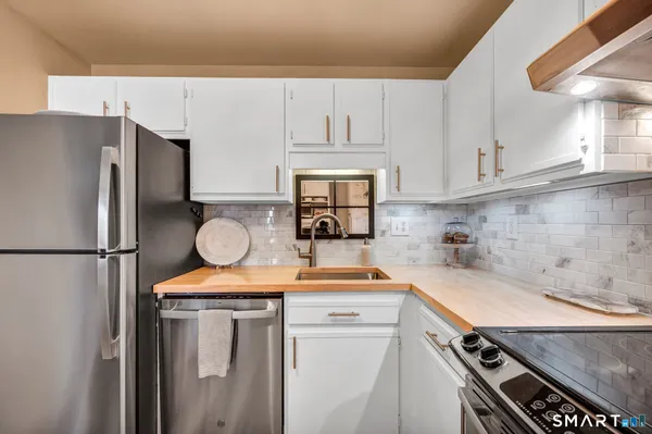 a kitchen with a refrigerator and a sink