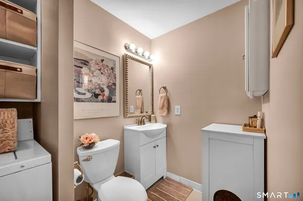 a bathroom with a toilet sink and mirror