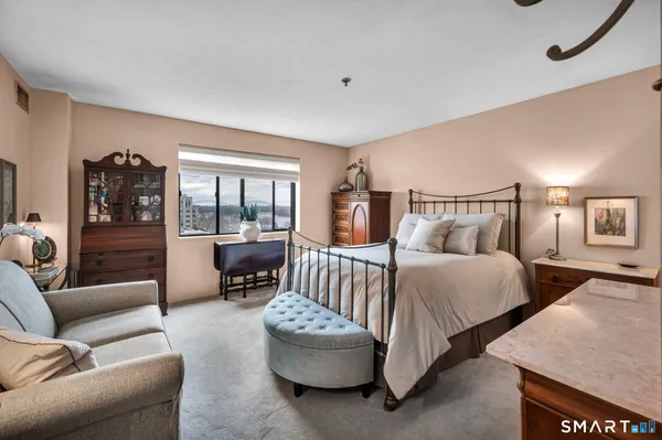 a bedroom with a bed and glass door