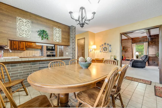 a dining room with furniture and window