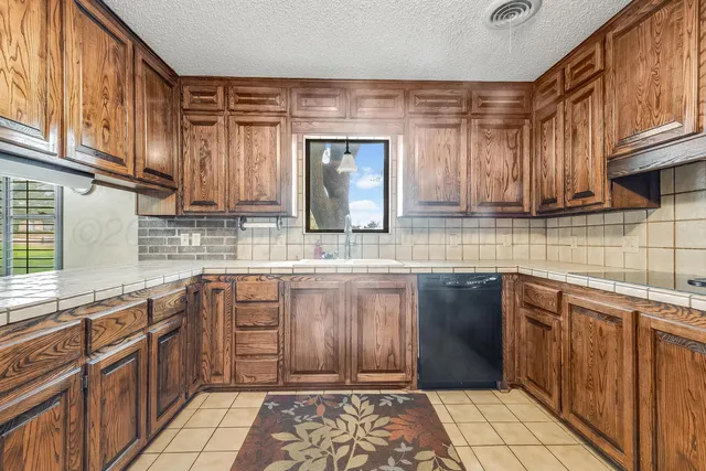 a kitchen with stainless steel appliances granite countertop a sink and cabinets