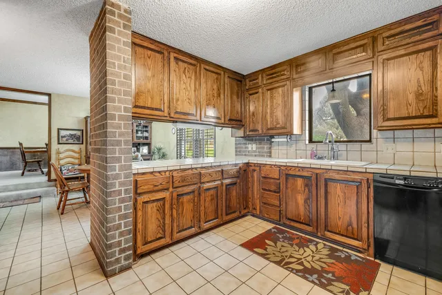 a kitchen with stainless steel appliances granite countertop sink stove and granite counter top