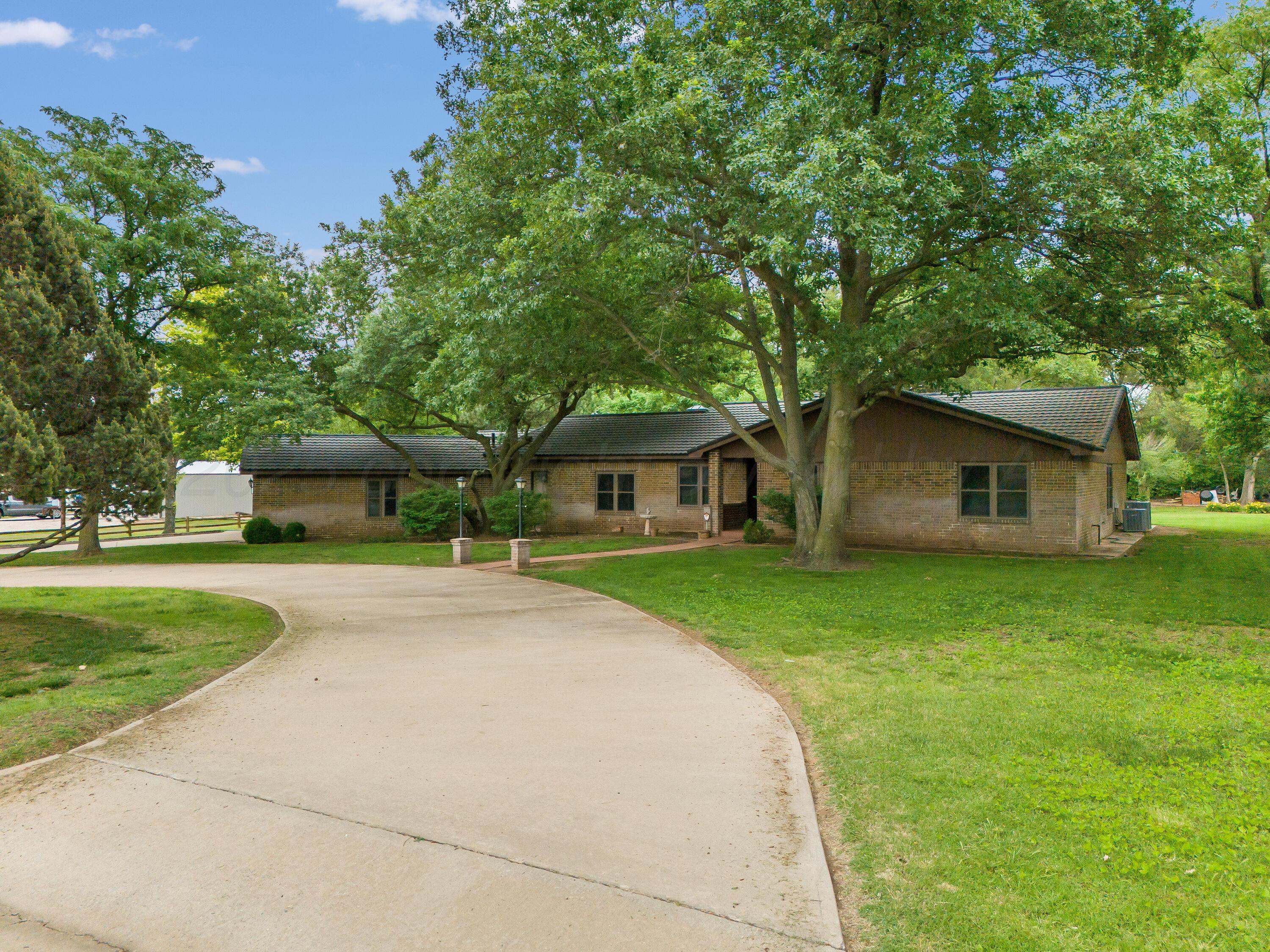 300 West 11th Street Wheeler, TX 79096 - Photo 2 of 49 a front view of a house with a garden