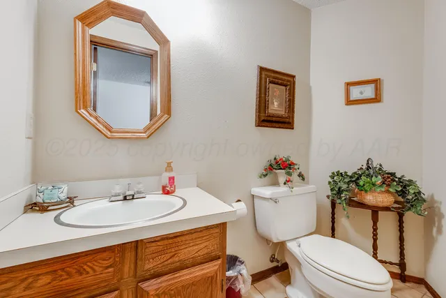 a bathroom with a sink mirror vanity and toilet