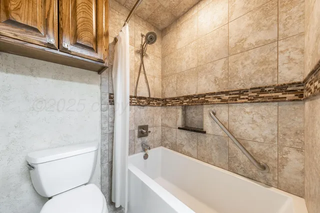 a bathroom with a toilet and a bathtub