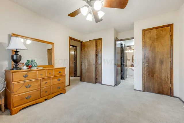 a spacious bathroom with a double vanity sink a large mirror and a shower