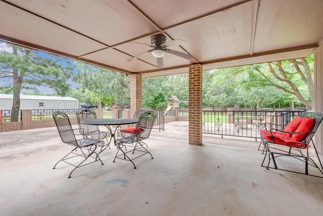 a view of a dining room with furniture water view and wooden floor