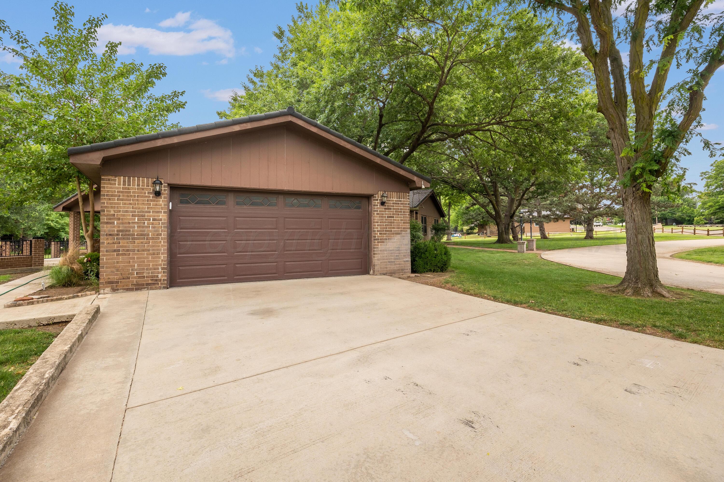 300 West 11th Street Wheeler, TX 79096 - Photo 41 of 49 front view of house with a yard and trees all around