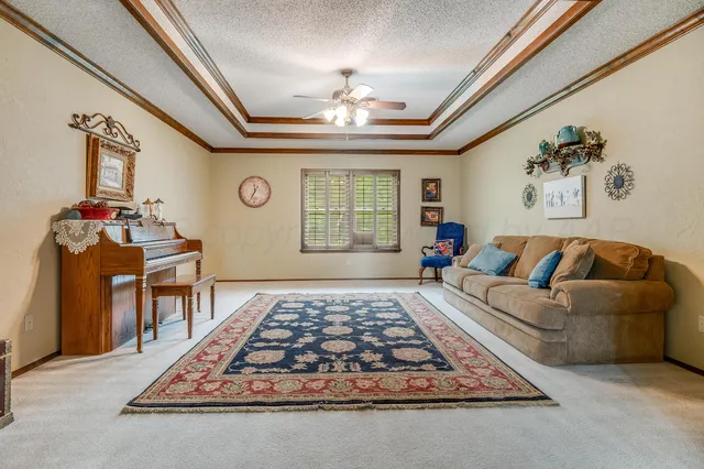 a living room with furniture and a chandelier