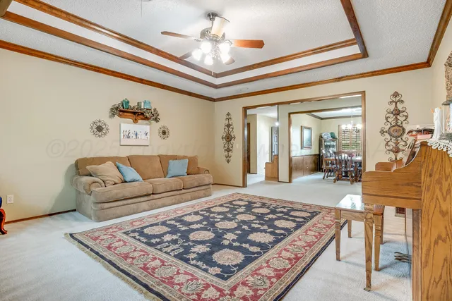 a living room with a couch and a chandelier