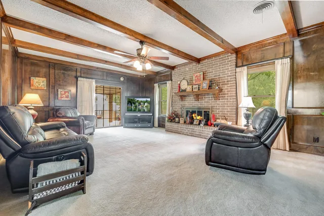 a living room with furniture and a floor to ceiling window