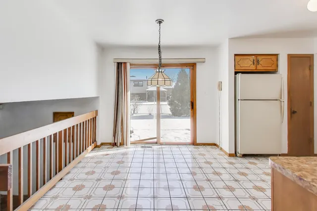 a view of a room with wooden floor and windows