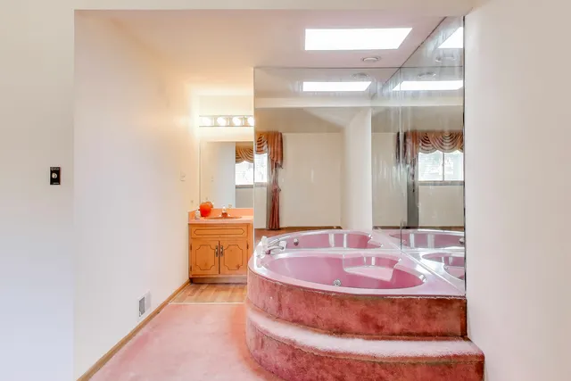 a bathroom with a mirror and a sink