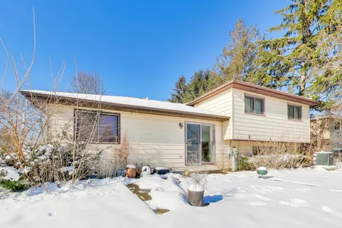 a backyard of a house with outdoor seating