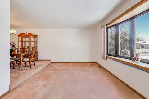 an empty room with windows and tables