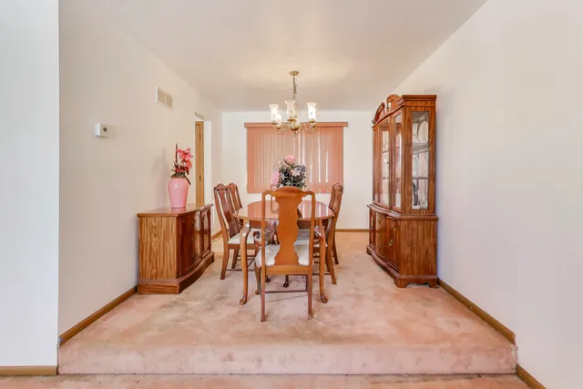 wooden floor in a hall with a dining table and chairs