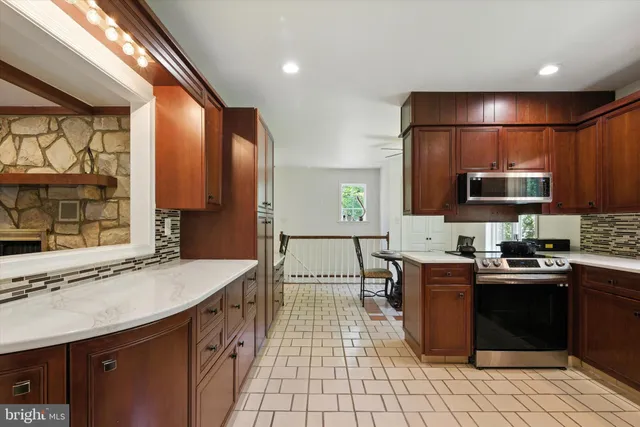 a kitchen with stainless steel appliances a sink stove and cabinets