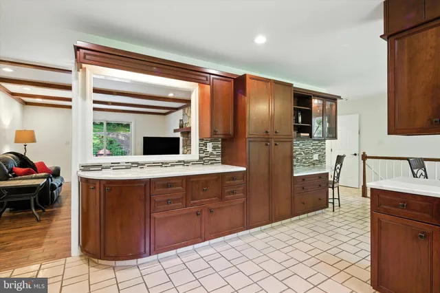 a kitchen with stainless steel appliances kitchen island granite countertop a refrigerator and a stove top oven