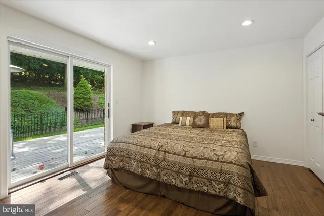a bedroom with a bed and glass door