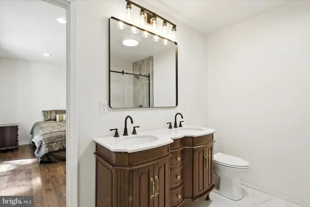 a bathroom with a toilet sink and mirror