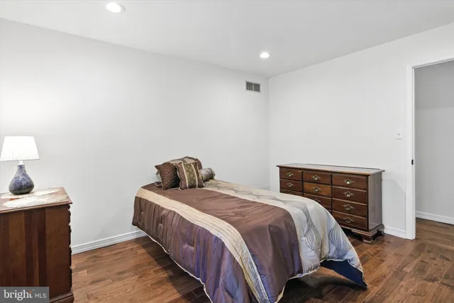 a bedroom with a bed and a lamp