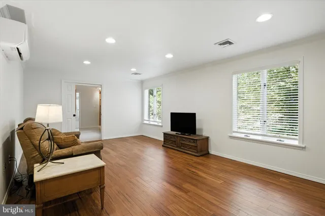a living room with furniture a window and a flat screen tv
