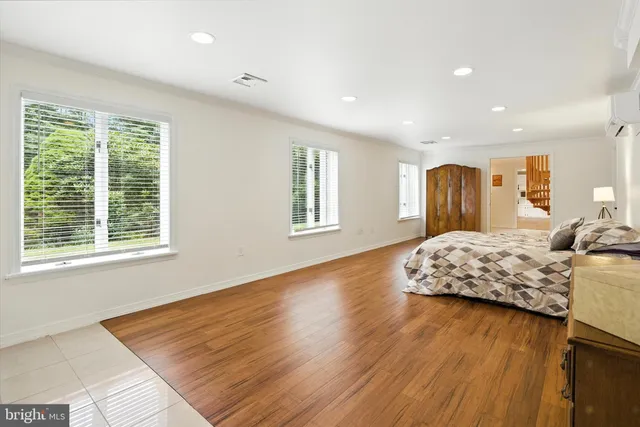 a spacious bedroom with a large bed and a dresser