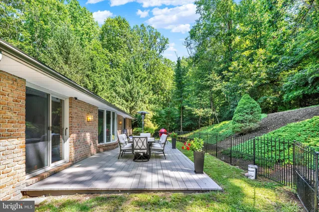 a view of backyard of house with green space