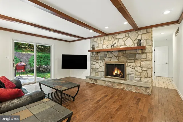 a living room with furniture a window and a fireplace