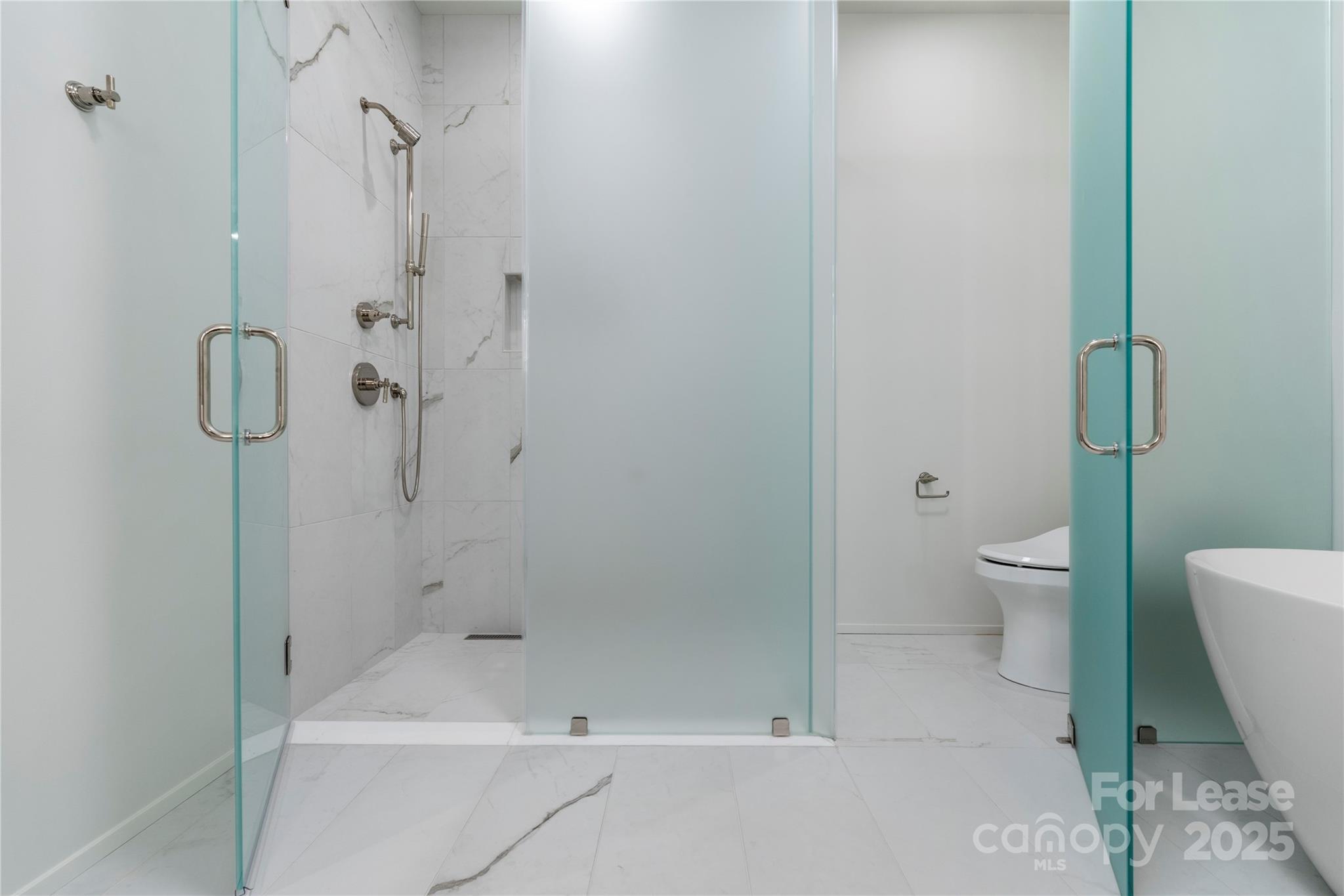 1500 Queens Road, Unit 204 Charlotte, NC 28207 - Photo 11 of 33 a bathroom with a shower and a toilet