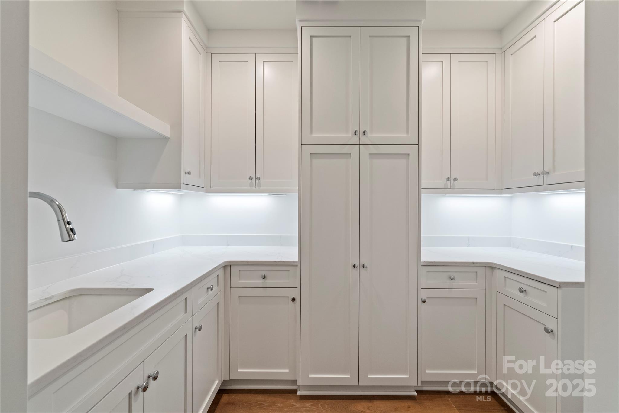 1500 Queens Road, Unit 204 Charlotte, NC 28207 - Photo 14 of 33 a view of cabinets and wooden floor