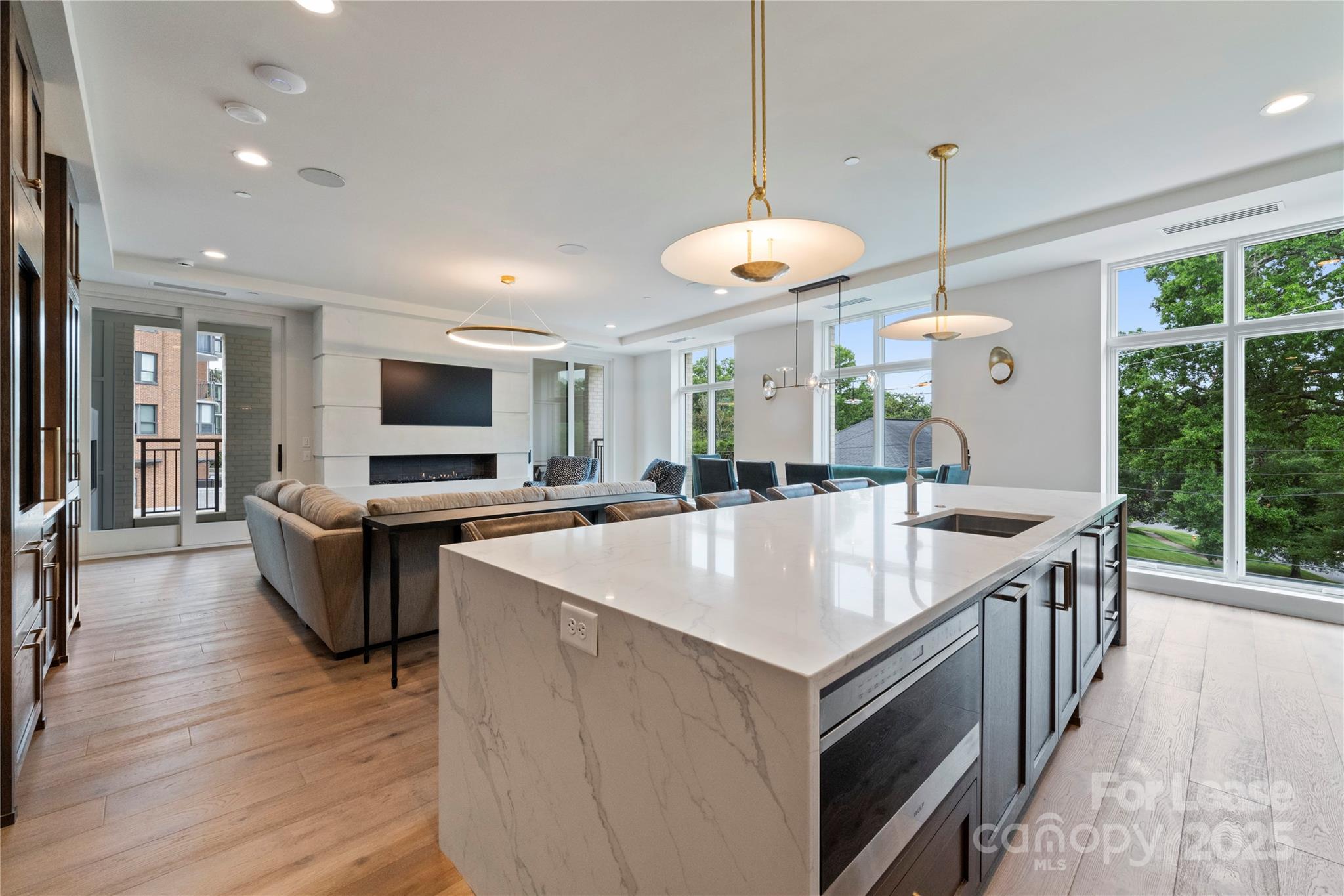 1500 Queens Road, Unit 204 Charlotte, NC 28207 - Photo 19 of 33 a large kitchen with kitchen island a large island in the center