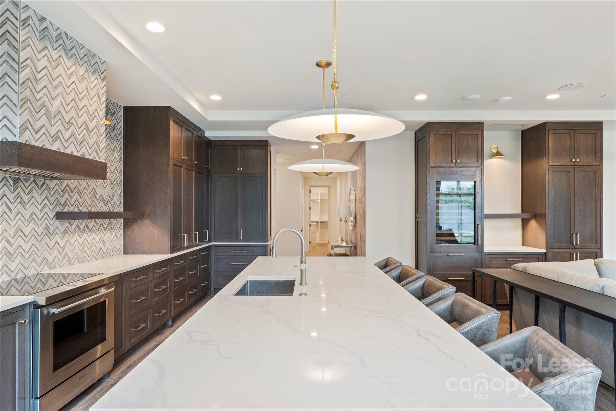 1500 Queens Road, Unit 204 Charlotte, NC 28207 - Photo 22 of 33 a large bedroom with a large bed and a chandelier