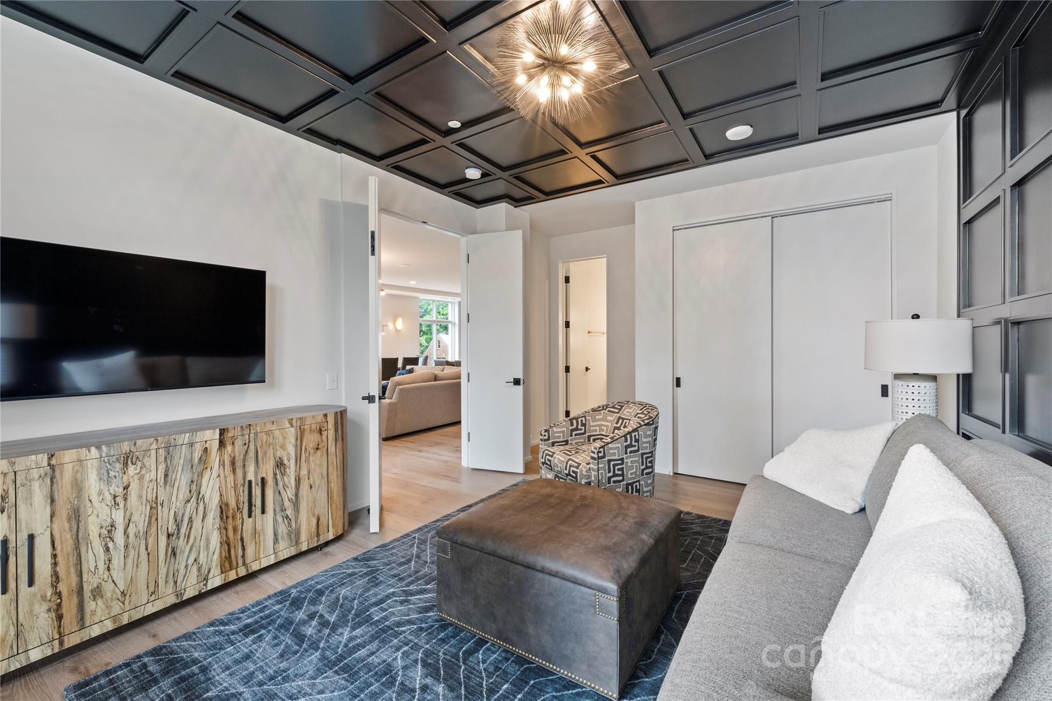 1500 Queens Road, Unit 204 Charlotte, NC 28207 - Photo 28 of 33 a living room with furniture and a flat screen tv