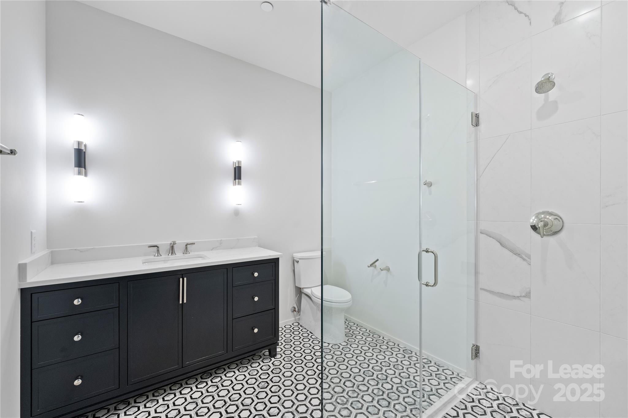 1500 Queens Road, Unit 204 Charlotte, NC 28207 - Photo 30 of 33 a bathroom with a double vanity sink toilet and shower