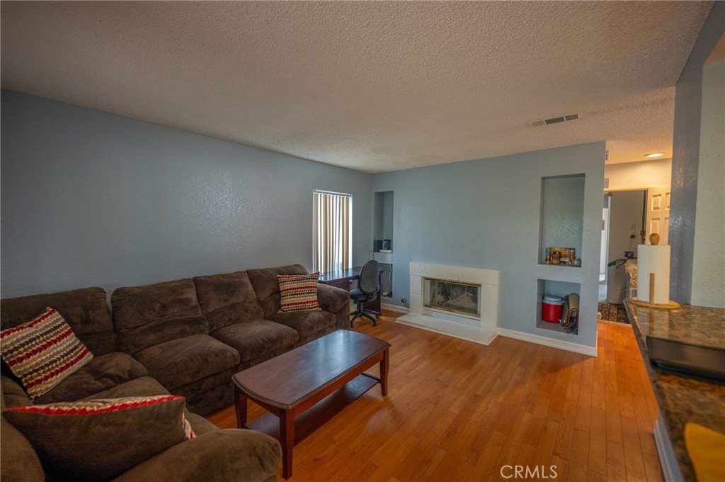 7444 Webster Street Highland, CA 92346 - Photo 14 of 37 a living room with furniture and a fireplace