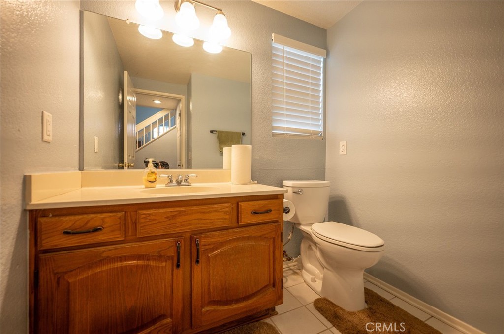 7444 Webster Street Highland, CA 92346 - Photo 16 of 37 a bathroom with a sink toilet and mirror