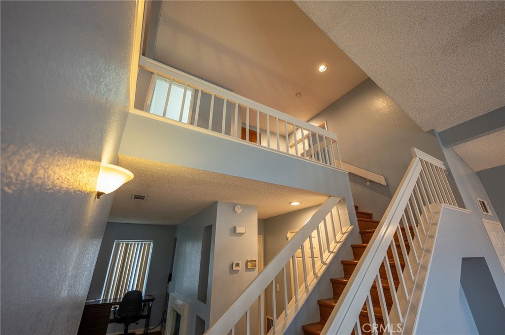 7444 Webster Street Highland, CA 92346 - Photo 17 of 37 a view of staircase with lots of frames on wall and windows