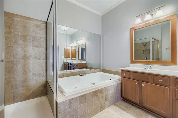 a bathroom with a tub a sink and mirror