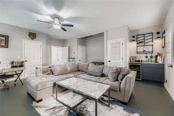 a living room with furniture and a chandelier