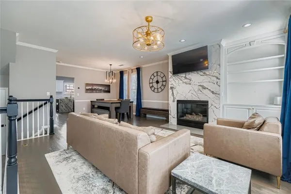 a living room with furniture a fireplace and a flat screen tv