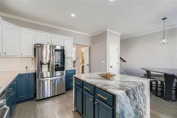 a kitchen with stainless steel appliances a refrigerator and a stove