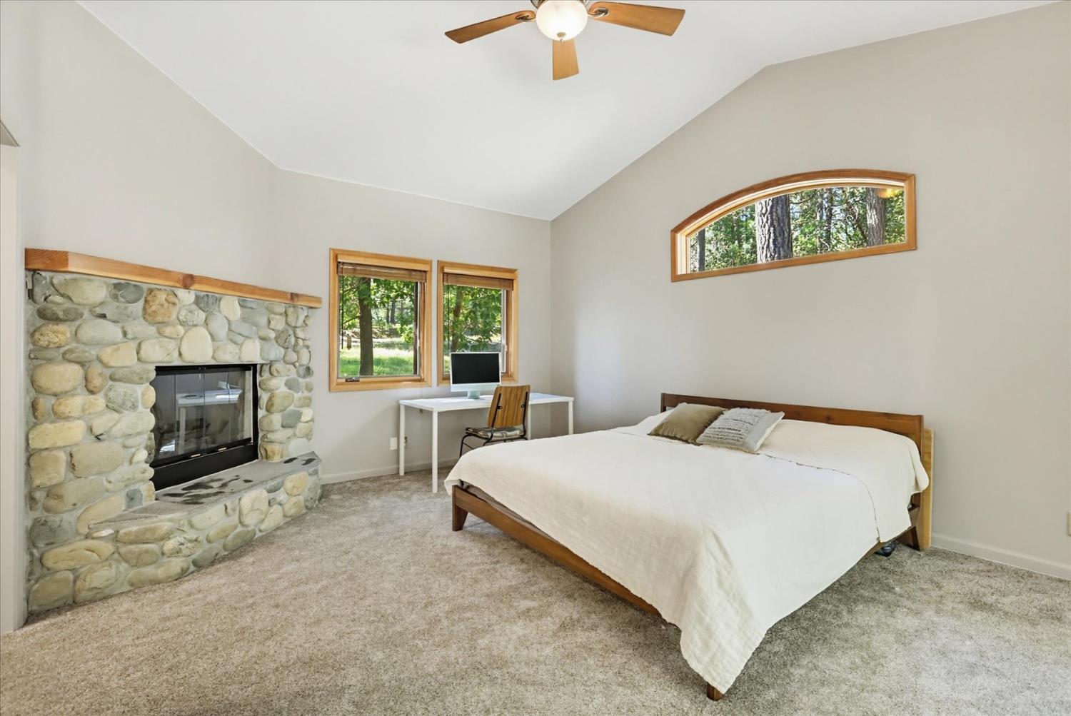 14517 North Bloomfield Road Nevada City, CA 95959 - Photo 28 of 78 a bedroom with a bed and a fireplace