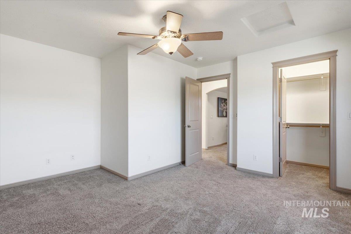 1183 North Buffalo Way Middleton, ID 83644 - Photo 31 of 47 Spacious room featuring neutral carpeting, white walls, and a ceiling fan with integrated lighting