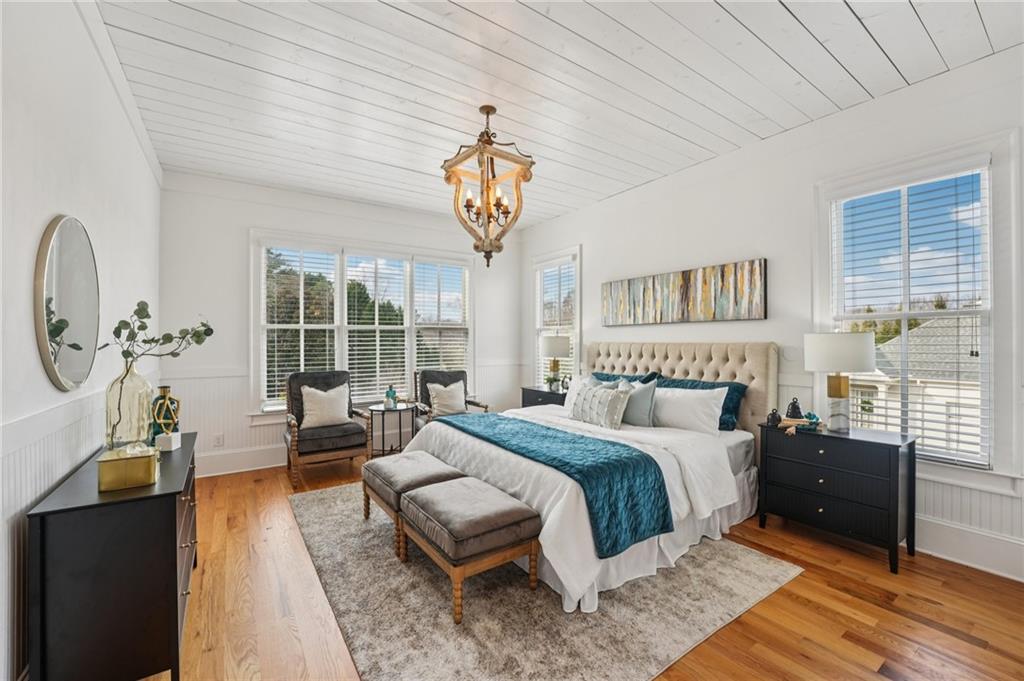 203 Trinity Way Canton, GA 30115 - Photo 20 of 77 a spacious bedroom with a bed and a chandelier
