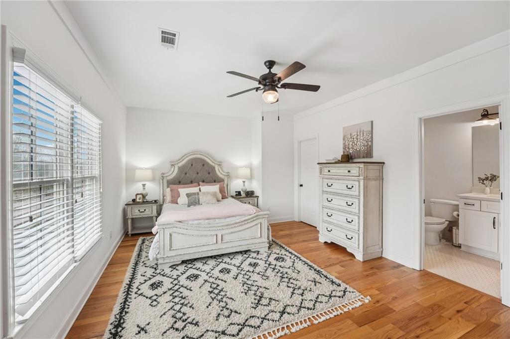 203 Trinity Way Canton, GA 30115 - Photo 44 of 77 a bedroom with a bed and a chandelier