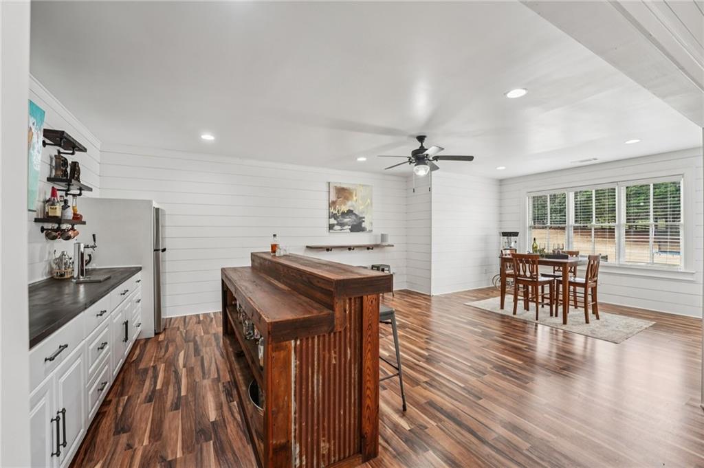 203 Trinity Way Canton, GA 30115 - Photo 57 of 77 a kitchen with kitchen island wooden floor and stainless steel appliances
