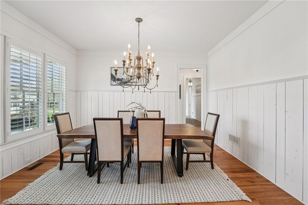 203 Trinity Way Canton, GA 30115 - Photo 7 of 77 a view of a dining room with furniture a chandelier and wooden floor