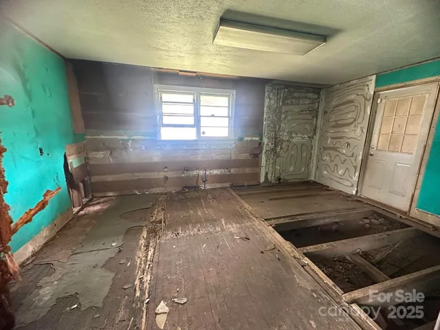 a view of an empty room with a fireplace